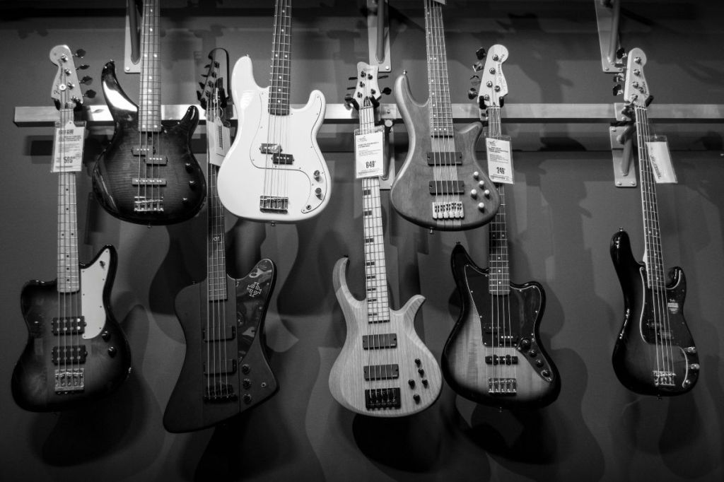 "8 Electric Guitars Hanged on Brown Steel Bar"