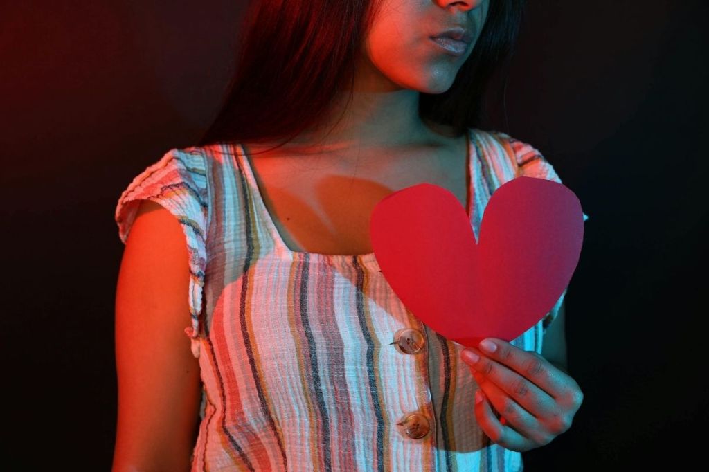 "A Woman Holding a Hearth Shape Red Paper"