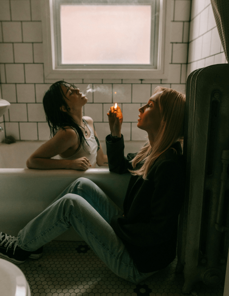 Girls Sitting in Bath Smoking Cigarettes
